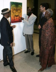 Jamaican actor Karl Bradshaw (right), has the rapt attention of Jamaica’s Ambassador to the United States, His Excellency Stephen Vasciannie, University of the West Indies (UWI) Professor Carolyn Cooper and founder of the International Reggae Poster completion Michael Thompson as they admire one of the 24 posters on display at the International Reggae Poster Exhibition held at the Marcus Garvey Hall of Culture at the Organization of American States (OAS) in Washington DC on Thursday, May 22, 2014.  (Photo by Derrick A. Scott)
