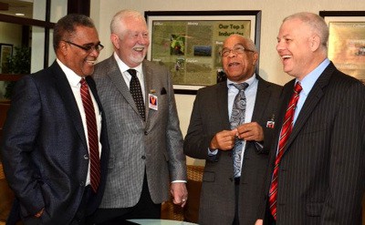 ALL SMILES: Dennis Morrison, Chairman of the Jamaica Tourist Board, (left) and Dr. Omar Davies, Minister of Transport, Works and Housing (2nd right), celebrate the announcement in Kingston with David Hall, Executive Chairman of VIP Attractions (right) and Terry Evans, President of Priority Pass. 