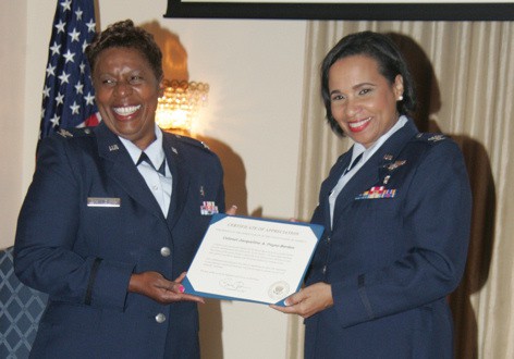 Col. Jacqueline Payne-Borden (right), receives the President of the United States certificate of Appreciation from Col. Sandra Tynes at a retirement ceremony held to honor Colonel Payne-Borden’s 28 years of service to the US Air Force. The retirement ceremony was held at Fort McNair Officers’ Club in Washington DC on Friday, July 18, 2014. (Derrick Scott photo)