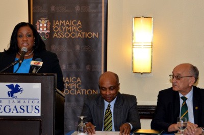 Minister with responsibility for Sport, Hon. Natalie Neita Headley, addresses a press conference held today (July 3) at the Pegasus hotel in New Kingston, where the team for the XX Commonwealth Games in Glasgow, Scotland, was announced. Also pictured are (from left): Secretary General of the Jamaica Olympic Association (JOA), Christopher Samuda; and President of the JOA, the Hon. Michael Fennell.
