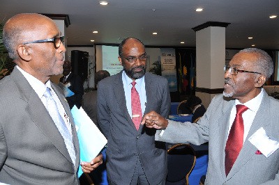 Easton Douglas, Chairman of the National Housing Trust (NHT), in discussion with Earl Samuels, Assistant General Manager, Jamaica National Building Society (JNBS) while Earl Jarrett, General Manager, JNBS listens keenly. Mr. Samuels, who is also a former Managing Director, of the NHT, says the discourse on affordable housing continues to exclude low income earners.  