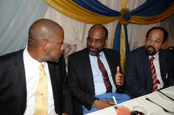 Earl Jarrett (centre), general manager of Jamaica National Building Society and lecturer Oswald Harding QC (right), debate with Dr. Wayne Henry, vice president government affairs of Scotiabank.  
