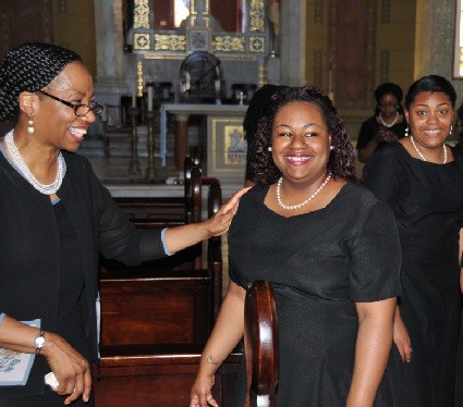 Dr. Harleston (left) shares a moment with choir members Taylor Witcher (centre) and Veronica Ambrose