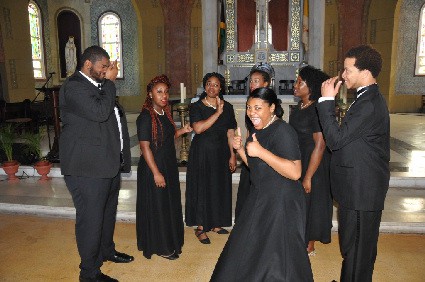 Choir member Veronica Ambrose gives two thumbs up, while others show their satisfaction