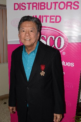 The Hon. Lascelles Chin, Founder and Executive Chairman of LASCO Affiliated Companies stands proud after being presented with the International Federation of Consular Associations (FICAC) Medal of Distinction on Tuesday, July 28. The presentation took place at the LASCO White Marl facility in St. Catherine following a tour which included Dr. the Hon. Arnold Foote, President of FICAC.