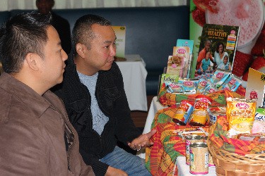 Representatives Ryan and Mark Chong from Encompass Sales look at LASCO Manufacturing products during B2B meetings held in Toronto, Canada to promote Jamaican products.