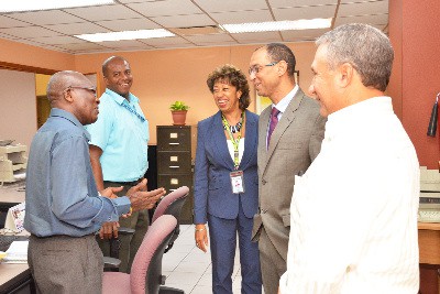 JAMPRO Chairman Don Wehby (second right) , Deputy Chairman of JAMPRO’s Board of Directors, Metry Seaga (right) and President of JAMPRO , Diane Edwards speak to past JAMPRO staff member Simeon Parker (left) and JAMPRO employee Karl Stafford (second left) during a recently held tour to meet the staff of JAMPRO’s Head Office in Kingston. 