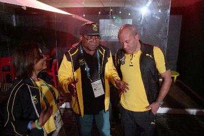Jamaica's Tourism Minister Edmund Bartlett (center) makes a point to Jason Hall, Deputy Director of Tourism, JTB during Luciano's performance at Jamaica House in Rio. Enjoying the vibe is wife Carmen Bartlett.