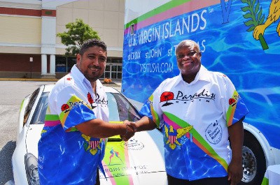 USVI Governor Kenneth Mapp (right) and Luis Corujo of Paradise Racing  celebrate the partnership in Glenn Dale, Maryland.  