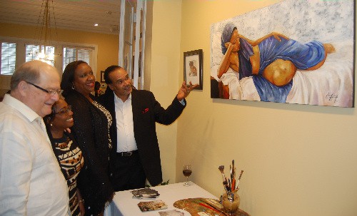 Renowned Jamaican Artist and Sculptor, Michael Escoffery (right), explains the concept of one of his pieces of art currently on display at the Embassy of Jamaica in Washington DC to (l-r) Charge d ’Affairs of the Embassy of Jamaica, Mrs. Marsha Coore Lobban, Jamaica’s Alternate Representative to the Organization of American States (OAS), Mrs. Juliet Hyatt and Permanent Representative of Bolivia to the OAS, Ambassador Diego Pary at the official launch of Mr. Escoffery’ s exhibition in commemoration of emancipation day and Jamaica’s 54th year of independence on Monday, August 1, 2016. (Photo by Derrick Scott)