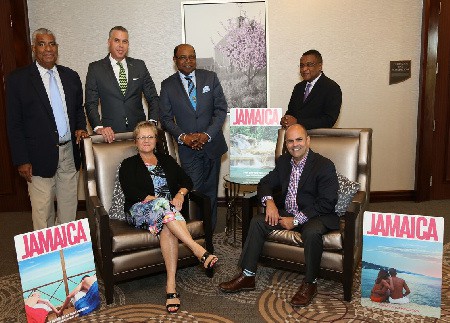Following a fruitful discussion with representatives from Canadian travel company Transat, Minister of Tourism Hon. Edmund Bartlett (third left, standing) joined (standing from left) Chairman of the Jamaica Tourist Board, John Lynch; Jamaica Tourist Board’s Regional Director – Canada, Philip Rose; Director of Tourism, Paul Pennicook; (seated, from left) Transat’s Product Director, Brenda McInerney; and Transat’s Product Buyer, Joe Couto for a photograph.