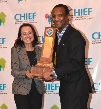 Stuart Bowe receives the coveted award from Karolin Troubetzkoy, President of the Caribbean Hotel and Tourism Association. Photo credit: Suzanne Ludwig - Ludwig & Co. 