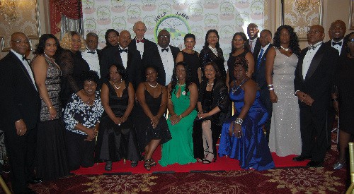 Jamaica’s Ambassador to the United States, her Excellency Audrey Marks, center, and Jamaica Counsel General to new York Trudy Deans, fifth from right, pose for a photo with members of the Help Jamaica Medial Mission at the organization’s 6th Annual fundraising Black Tie affair at Hanover Manor in East Hanover, New Jersey, Saturday November 12.2016. (Photo Credit) Derrick Scott. 