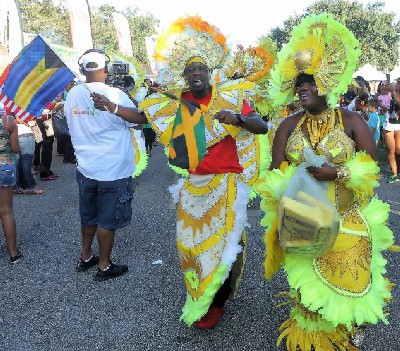Comedian and actor Chris "Johnny" Daley leads the Bahamian Junkanoo Parade at the 15th annual Grace Jamaican Jerk Festival in Sunrise