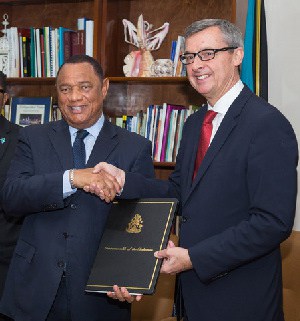 At a signing ceremony attended by Perry Christie, Prime Minister of The Bahamas (left) and Michael Bayley, president and CEO, Royal Caribbean International (right)