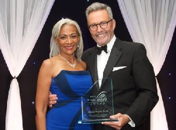 Dian Holland (left), Jamaica Tourist Board Business Development Manager for the western region, accepted the award from TravelAge West Senior Vice President Bruce Shulman