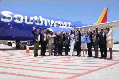 Executives and flight crew from Southwest along with Cayman Islands Tourism and Aviation officials celebrate the arrival of the first flight to Grand Cayman