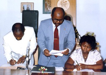 The Right Hon. Dr. Denzil L. Douglas signing the Oath Book in 1989 after being sworn in as MP for the first time in St. Kitts and Nevis
