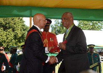 John Lynch (right) receives his Order of Distinction in the Rank of Commander Class (CD) from Governor-General, His Excellency the Most Hon. Sir Patrick Allen