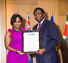Niyala A. Harrison (President) and Honorable Commissioner Dale V.C. Holness after reading and presenting a proclamation from Broward County to the Caribbean Bar Association