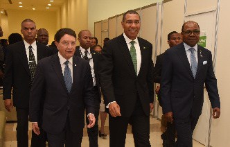 Prime Minister of Jamaica, Andrew Holness (centre) is escorted by UN World Tourism Organisation Secretary-General, Taleb Rifai, and Minister of Tourism, the Hon. Edmund Bartlett, to the opening of the Global Conference on Jobs and Inclusive Growth: Partnerships for Sustainable Development 
