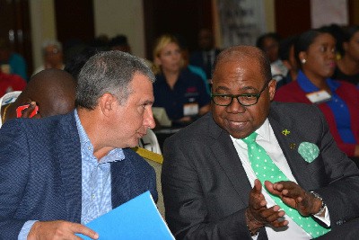 Metry Seaga and Edmund Bartlett discuss investment in tourism supplies for Jamaica