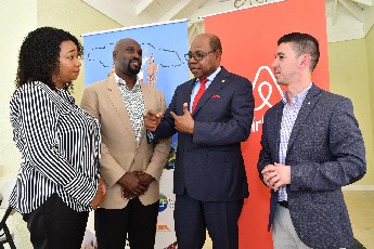 Tourism Minister, Hon. Edmund Bartlett (second right) engages in dialogue with (from left) Vice President, Jamaica Homesharing Association, Shere-Ann Anderson; President, Jamaica Homesharing Association, Havanah Llewellyn and Head of Public Policy, Central America and the Caribbean, Airbnb Inc, Carlos Muñoz.