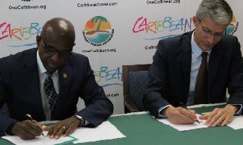 CTO secretary general Hugh Riley (left) and Bitt CEO Rawdon Adams (right) sign MOU