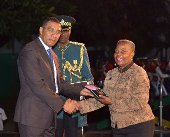 JNAF President, Ms. Joan Howard receiving the prestigious PM Medal of Appreciation Award from Prime Minister Andrew Holness of Jamaica