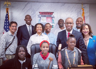 Members of the construction team of Messam Construction; Brownsville Middle School students, HMB attorney, Marlon Hill and State Attorney Katherine Fernandez Rundle