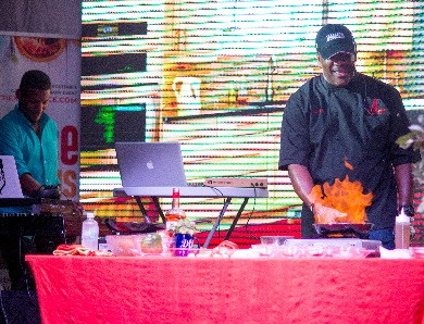 Chef Irie Spice doing a live demo at Taste The Islands Experience with Dj Richie D providing the music 