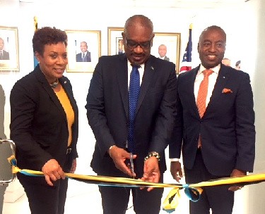 Bahamas Prime Minister, the Honourable Hubert Minnis, at center cuts the ribbon officially opening the new location of the Bahamas Consulate General Miami.  Right  of the PM is Minister of Foreign Affairs, The Honourable, Darren Henfield and to his left, Bahamas Consul General Miami, Mrs. Linda Mackey.