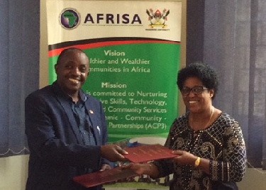 Sharon Brown, the founder and president of Son Shine Global Partners, is pictured in Uganda with Dr. Kansiime Michael, head of AFRISA Secretariat at Makerere University, after signing a memorandum of understanding.