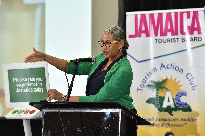 Jamaica Vacations Ltd’s Manager of Cruise Tourism, Francine Haughton, explains the functions of the ‘Happy or Not’ digital monitor, to Tourism Action Club members during the World Tourism Day Forum held on September 27, 2018 at the Montego Bay Convention Centre.