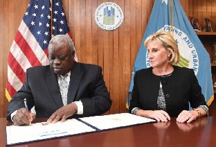 Governor Mapp and HUD Deputy Secretary Pamela Patenaude sign off on the final paperwork granting the Virgin Islands $243 in recovery funds.