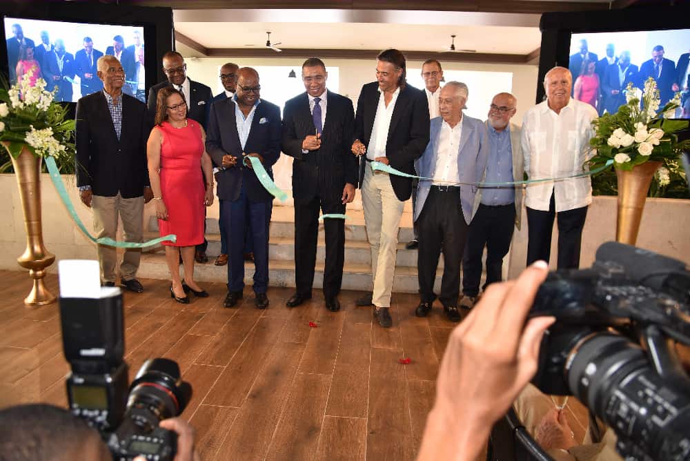Prime Minister Andrew Holness (C) cuts the ribbon with Minister of Tourism, Hon Edmund Bartlett (2nd L) to officially open Excellence Oyster Bay in Trelawny. Joining in the moment are from L-R, John Lynch, Chairman of the Jamaica Tourist Board, Hon Shahine Robinson, Minister of Labour and Social Security, Donovan White, Director of Tourism, Jamaica Tourist Board, Reverend Stephen Henry, Antonio de Montaner, CEO Excellence Group and owners Hans Jochen Kaehne, Pedro de Montaner, Pedro Pascual and Martín Santandreu.