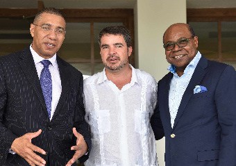 Prime Minister Andrew Holness (L) pauses on the steps of the newly opened Excellence Oyster Bay property in Trelawny. Joining him are Minister of Tourism, Hon Edmund Bartlett (R) and Rafael Matas, Corporate Director, Excellence Group Luxury Hotel and Resorts in Jamaica