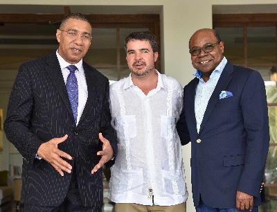 Prime Minister Andrew Holness (L) pauses on the steps of the newly opened Excellence Oyster Bay property in Trelawny. Joining him are Minister of Tourism, Hon Edmund Bartlett (R) and Rafael Matas, Corporate Director, Excellence Group Luxury Hotel and Resorts in Jamaica. 