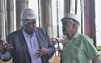 EPA Director Dr Vincent Adams listens to a point being made by Master Distiller Sean Caleb during the visit to DDL operations at Diamond