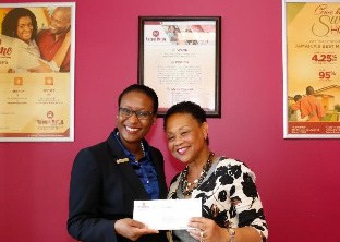 Camille Edwards, Global Scholars Coordinator, The School Board of Broward County, Florida (R) is pleased to receive sponsorship check from Suzette Rochester Lloyd, Chief Representative Officer, Victoria Mutual - Florida Representative Officer