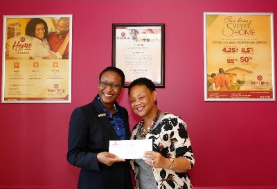 Camille Edwards, Global Scholars Coordinator, The School Board of Broward County, Florida (R) is pleased to receive sponsorship check from Suzette Rochester Lloyd, Chief Representative Officer, Victoria Mutual - Florida Representative Officer