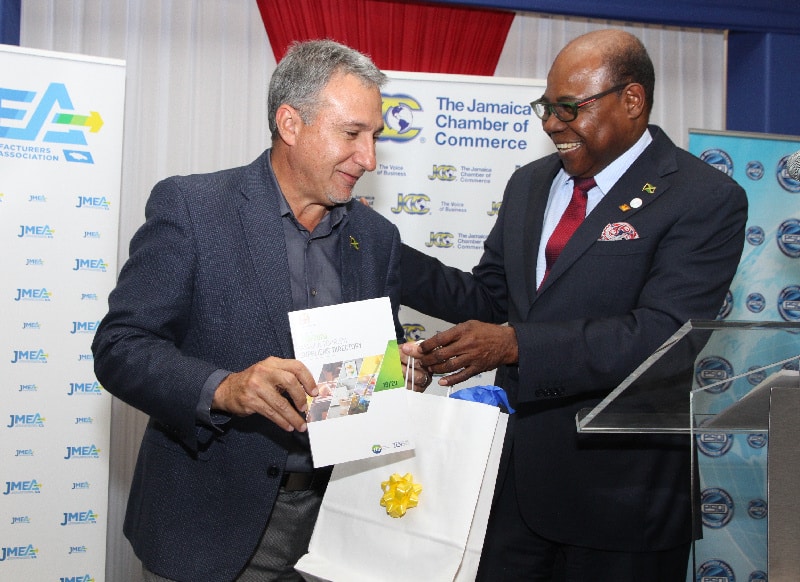 Hon Edmund Bartlett, presents a copy of the 2019/2020 Jamaica Tourism Suppliers Directory to the Jamaica Manufacturers and Exporters' Association (JMEA) President, Metry Seaga. 
