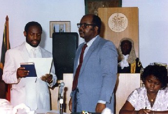 Rt Hon Dr Denzil L Douglas (left) being sworn in as a Member of Parliament in 1989 in St Kitts and Nevis