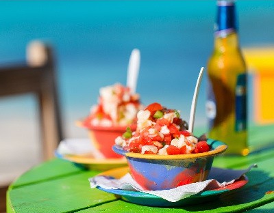 Where To Find The Most Authentic Food in the Caribbean, conch salad with authentic Bahamian beer