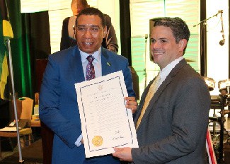 Prime Minister, the Most Hon. Andrew Holness accepts a proclamation by Brian Kemp, Governor of Georgia declaring Saturday, April 20th as Andrew Holness Day in the state of Georgia in recognition of his official visit to that state.