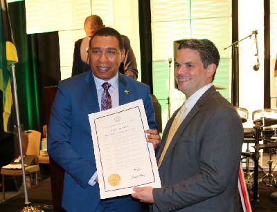 Prime Minister, the Most Hon. Andrew Holness accepts a proclamation by Brian Kemp, Governor of Georgia 