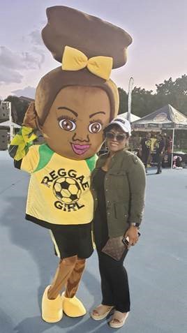 Jamaica Tourist Board Deputy Director of Tourism, Marketing Camile Glenister poses with Reggae Girlz mascot Toya 