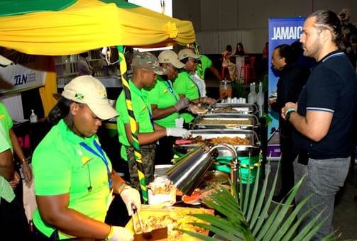 Members of the Culinary Federation of Jamaica serving up samples of Jamaican fare to attendees at Caribbean305.