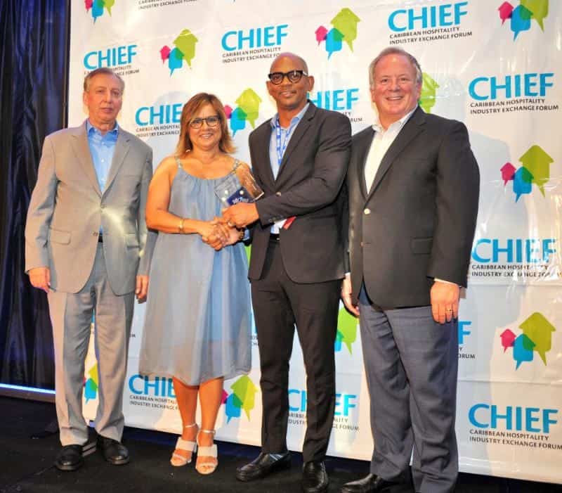 Paul Collymore of The Landings Resort & Spa in St. Lucia is congratulated by (from left) CHTA's Frank Comito, Patricia Affonso-Dass and Bill Clegg.