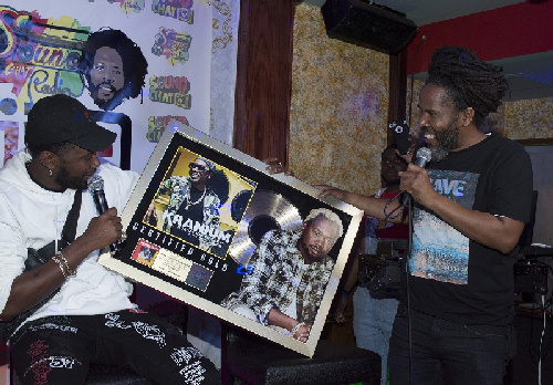 Chin presents Dancehall star Kranium with RIAA Gold certification plaque at Sound Chat Radio Live